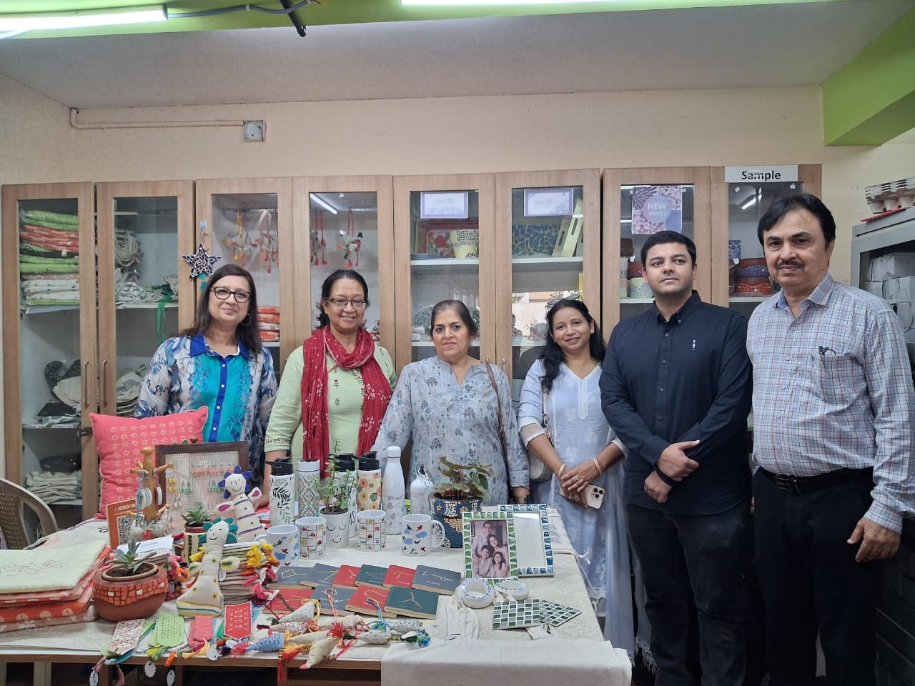 Visitors gathered beside a display of handmade crafts at PRAGATI